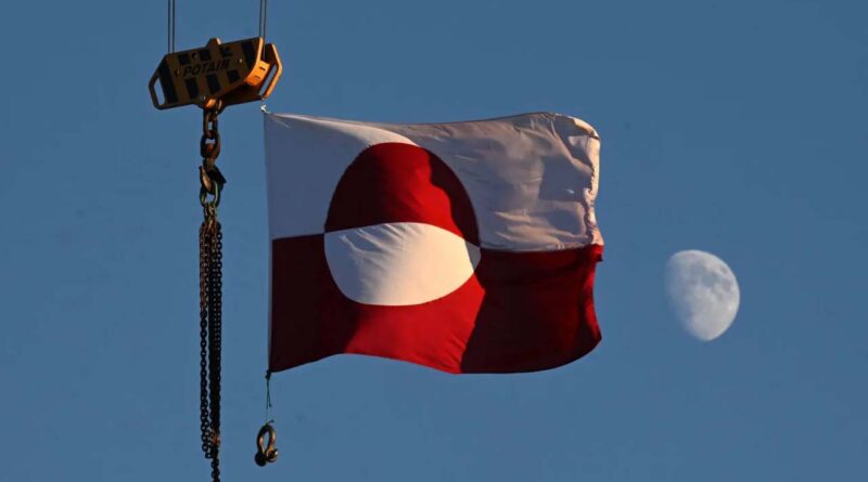 A flag of Greenland hangs from a crane in the city of Nuuk, western Greenland