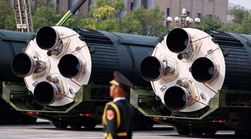 A member of the PLA stands in front of DF-5C nuclear missiles
