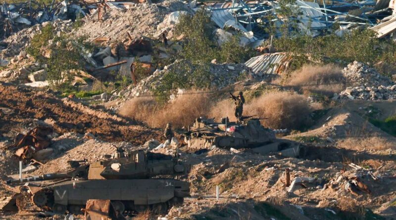 Israeli soldiers and tanks stand in Gaza, as seen from the Israeli side of the Israel-Gaza border