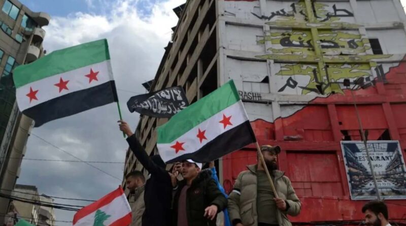 People carry Syrian flags of the opposition as they celebrate the ouster of the Assad regime in Damascus