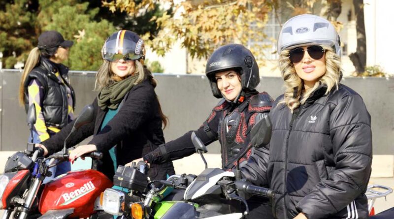 women sitting on bike