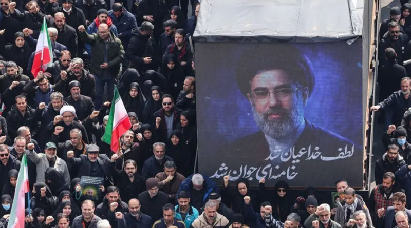 A screen displays a portrait of Iran’s new Supreme Leader Mojtaba Khamenei