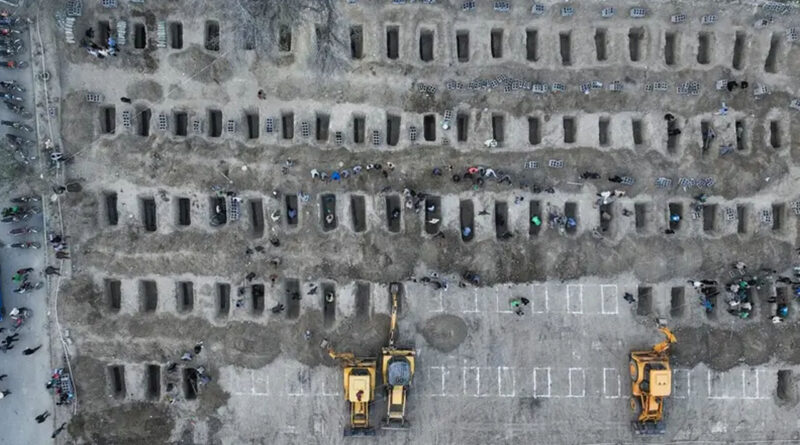 aerial picture of mourners dig graves during the funeral for children killed in a strike on a primary school in Iran’s Hormozgan province in Minab on March 3, 2026
