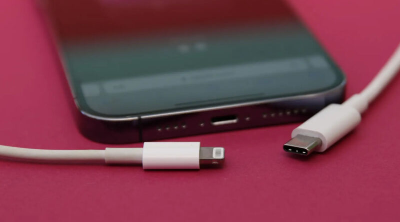 two charger port placed beside a mobile phone