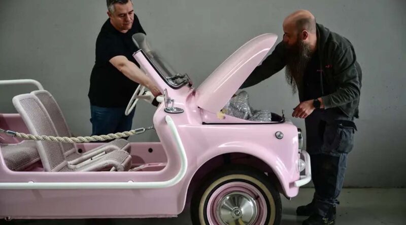 Owner of the Officine Gentile garage, Giovanni Gentile (L) and a worker inspect a finished model of the Fiat 500 Jolly Lido at the Officine Gentile garage in Turin