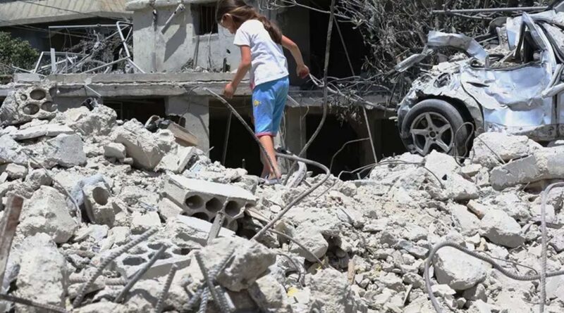 A displaced girl walks on top of her family's home, destroyed by the Israeli military, upon her return to their village in Deir Qanoun en Nhar, south Lebanon, on June 15, 2026