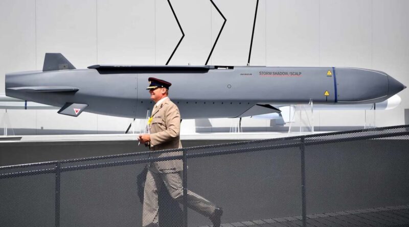 A member of the military walks past an MBDA Storm Shadow-Scalp missile at the Farnborough Airshow, southwest of London, on July 17, 2018