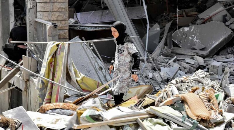 A woman inspects the rubble of a collapsed building in the town of Nabatieh al-Fawqa in southern Lebanon on June 23, 2026