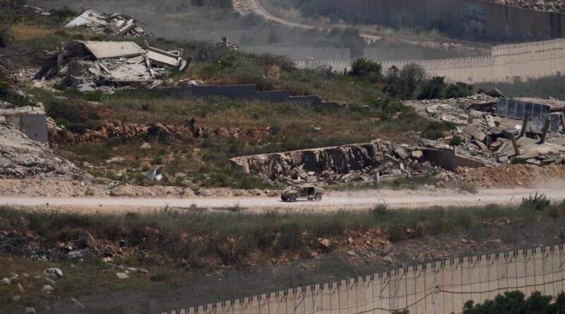 An Israeli military vehicle moves past destroyed buildings in southern Lebanon as seen from northern Israel, Sunday, June 21, 2026