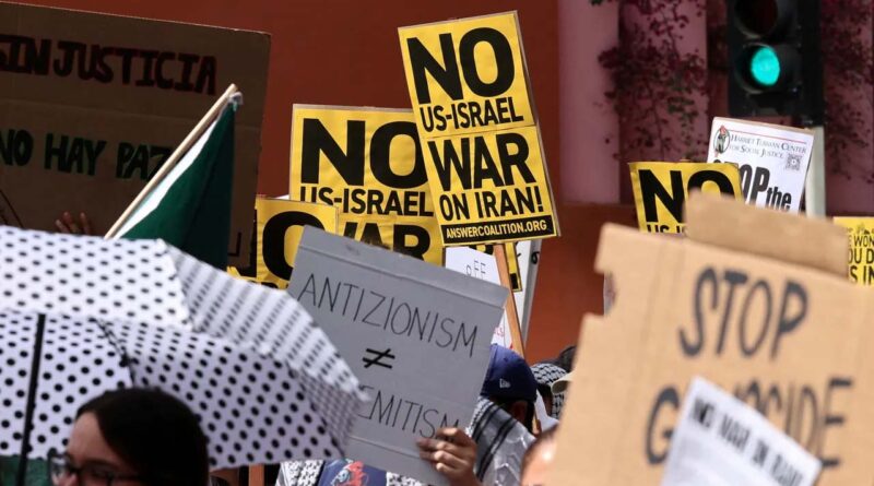 No US-Israel war on Iran placards are held as people attend an anti-war demonstration in Los Angeles, US