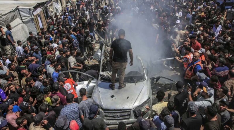 Palestinians inspect a destroyed vehicle following an Israeli airstrike in Gaza City, Gaza Strip, 18 June 2026
