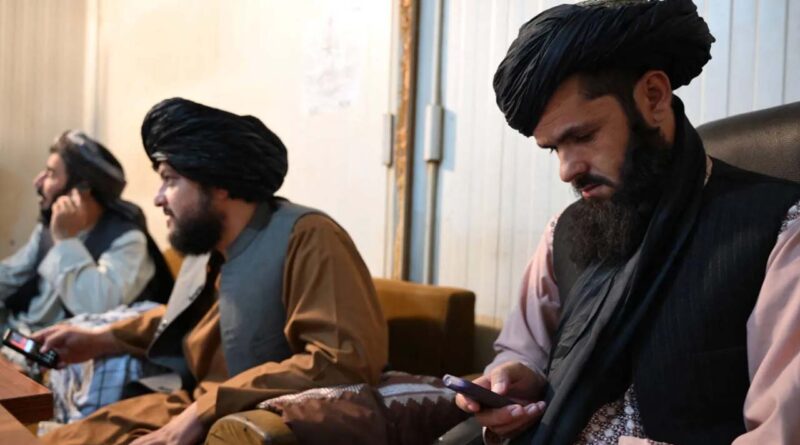Taliban administrative staff use feature phones at the Department of Information and Culture building in Kandahar on June 22, 2026