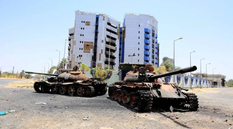 Two damaged tanks outside the central bank building in Khartoum during fighting